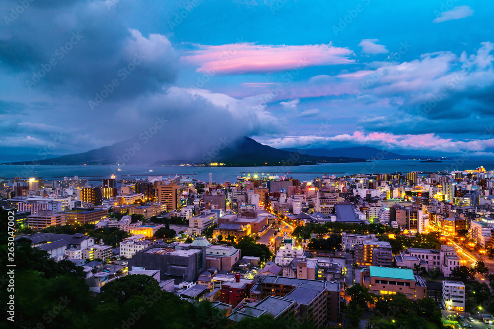 Fototapeta premium View of mountain Sakurajima an active volcano. Aerial view of Kagoshima city in Japan at sunrise