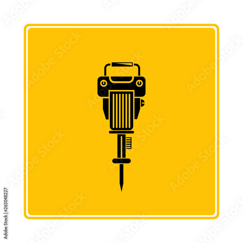 electric drill machine on yellow background