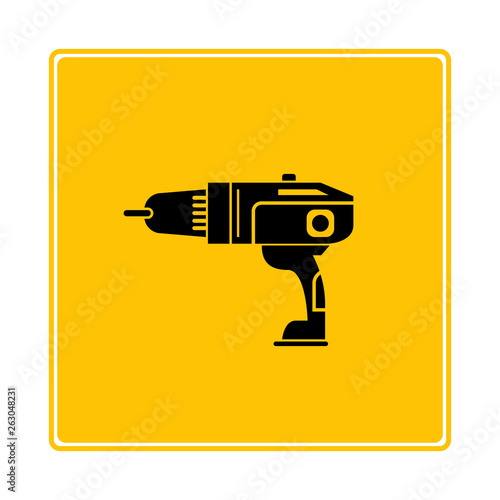 electric drill machine on yellow background