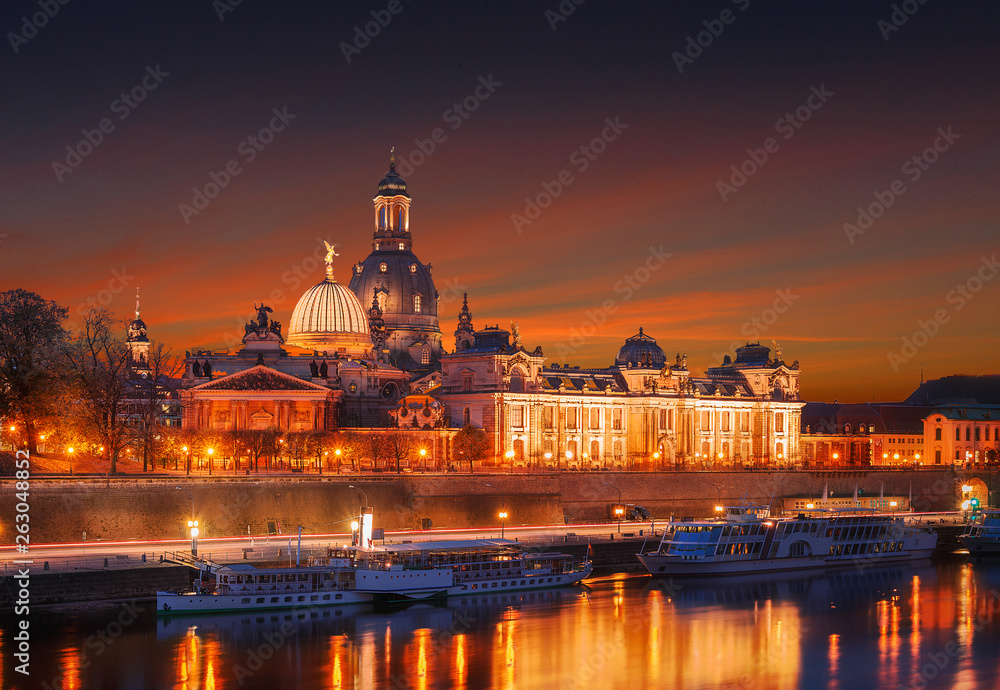 Fantastic colorful sunset in Dresden with dramatic sky, over the Elbe river. Old Town glowing in lighten reflected in the calm water. Picturesque unusual scene. Creative image. Dresden panorama