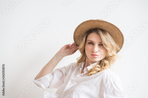 Sexy girl on a white background in a village hat