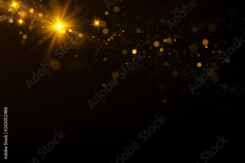 Sparkling golden particles explosion on black background