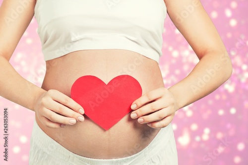 Wallpaper Mural Close up of a cute pregnant belly and red heart Torontodigital.ca