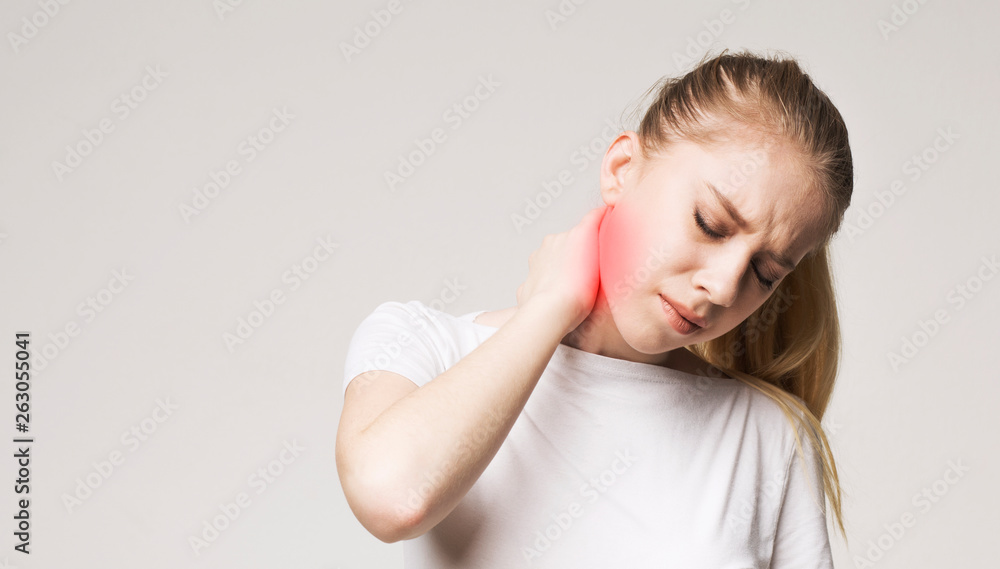 Tired woman massaging her painful neck, panorama Tired woman massaging her painful neck, panorama