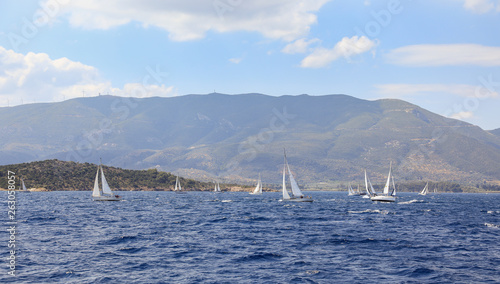 Summertime many sailboats sailing off the coast of the Poros island, Saronic Gulf, Greece.