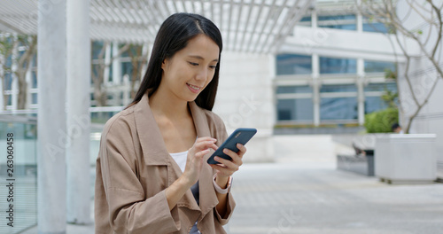 Woman use of mobile phone in city