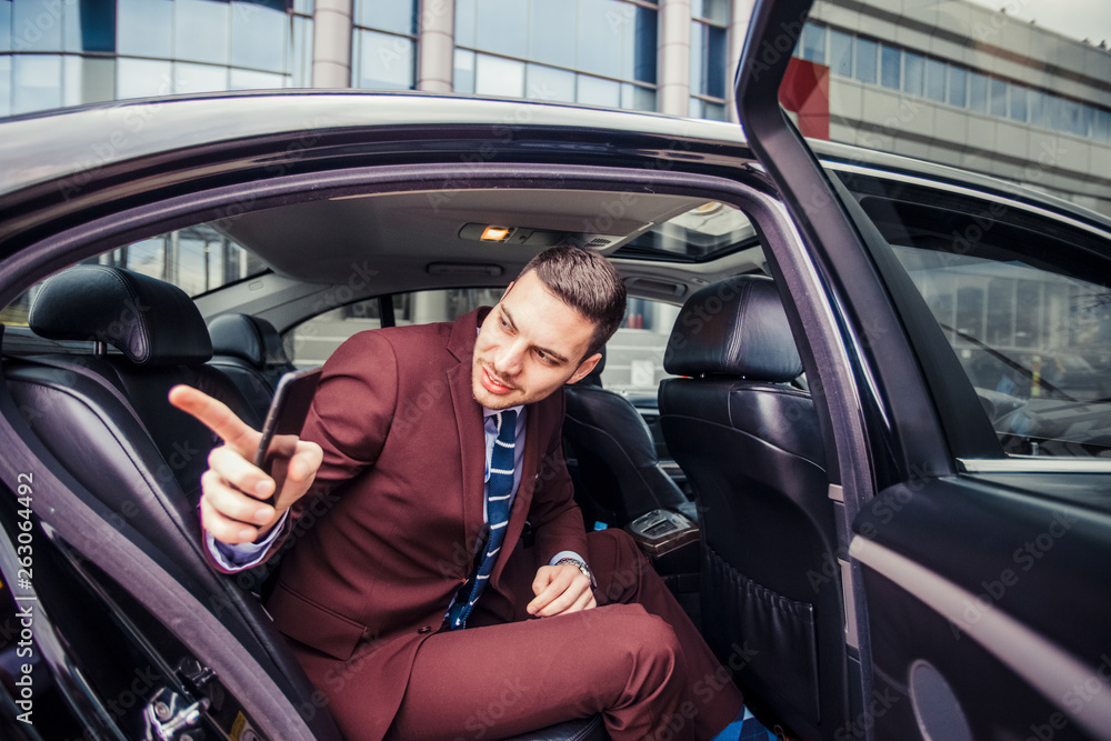 Businessman going out of his car
