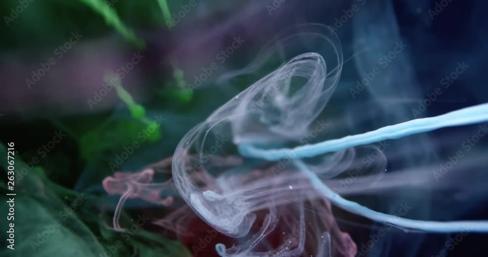 Colourful Red Green Blue RGB Paint Threads and Drops Mixing in Water. Ink swirling. Underwater 4K Macro Shot. Colourful Red Green Blue RGB Paint Threads and Drops Mixing in Water. Ink swirling. Underwater 4K Macro Shot.