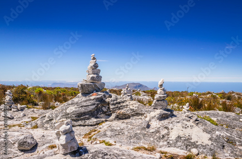 View of man made stone structures built on Table Mountain surrounded by green fynbos bush, Cape Town, South Africa