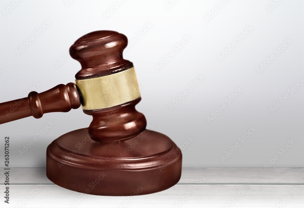 Judge hammer and house on brown wodden table and wall background Judge hammer and house on brown wodden table and wall background