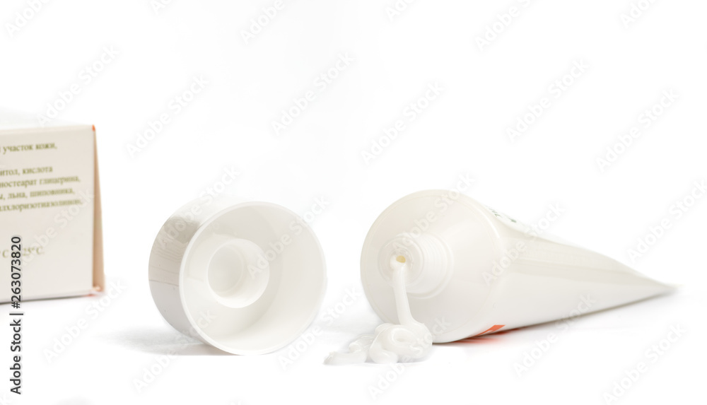Gel, cream, ointment for external use squeezed out of a tube and the cover next to a white background Gel, cream, ointment for external use squeezed out of a tube and the cover next to a white background