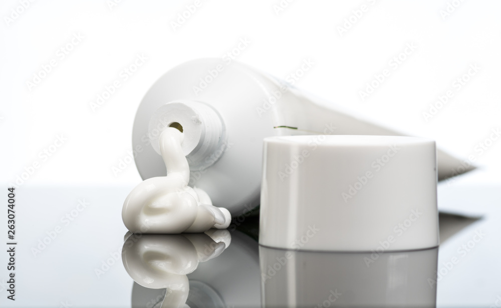 Gel, cream, ointment for external use squeezed out of a tube and the cover next to a white background Gel, cream, ointment for external use squeezed out of a tube and the cover next to a white background