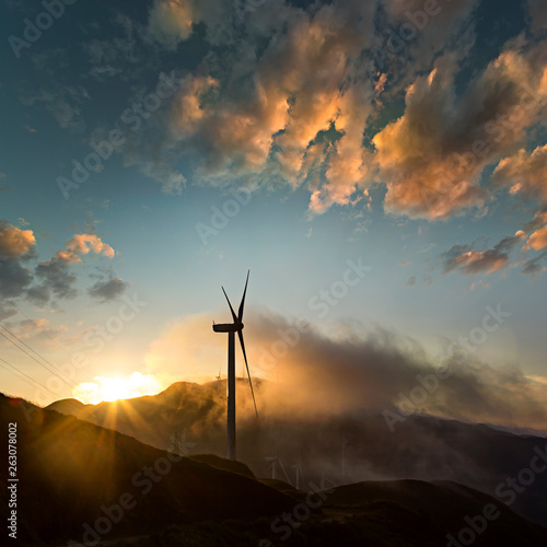 Wind power generator before sunrise sunset