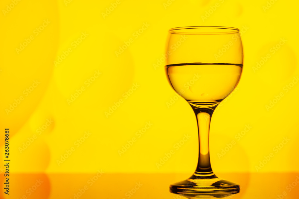 transparent glass with water and oily drops on background transparent glass with water and oily drops on background