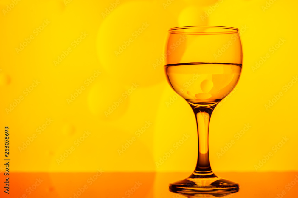 transparent glass with water and oily drops on background transparent glass with water and oily drops on background