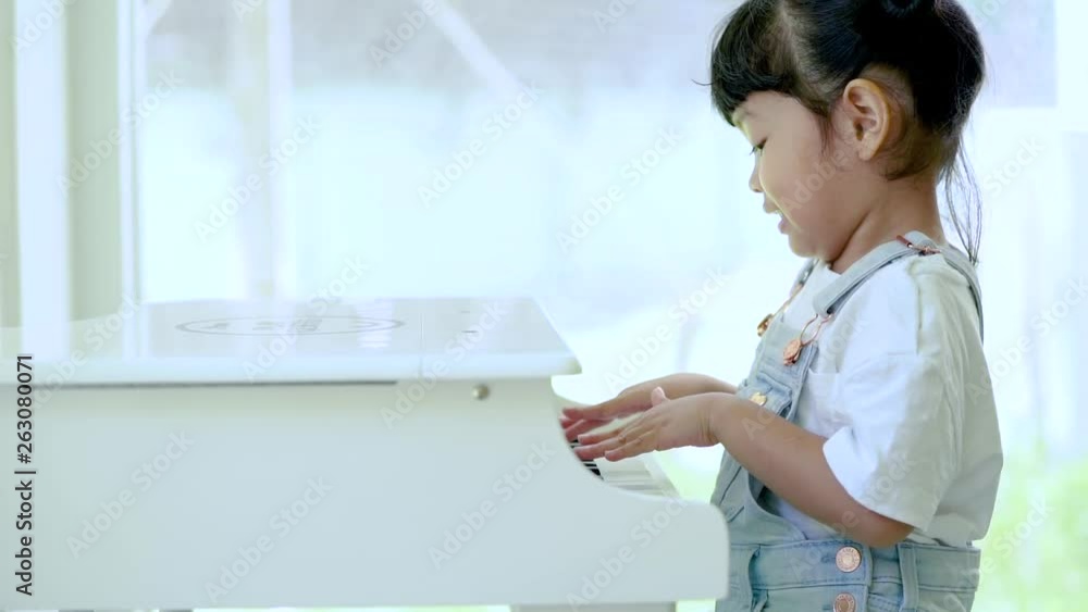 Kid learning to play piano with happiness. music concept. Kid learning to play piano with happiness. music concept.