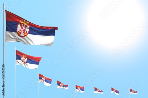 wonderful any holiday flag 3d illustration. - many Serbia flags placed diagonal on blue sky with space for your text