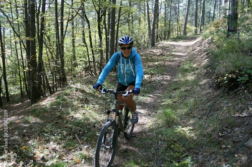A young woman riding a Bicycle on a forest trail, Crimea, Russia.