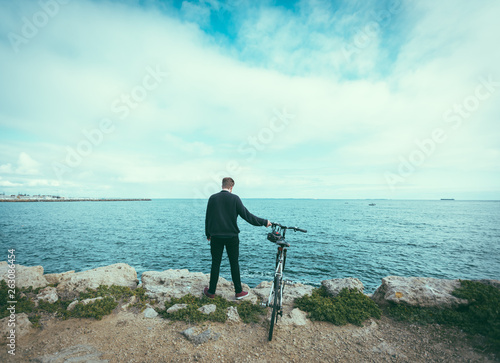 Man holding bike upright