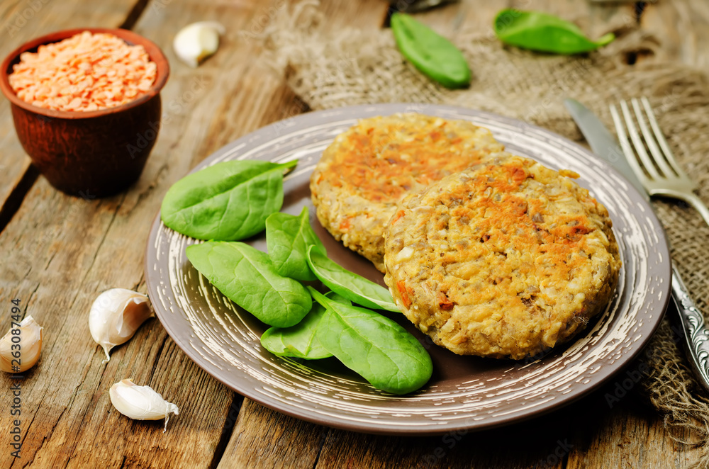 red lentil seeds cashew carrot burgers with fresh spinach leaves