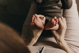 Baby feet in mother hands. Mom and her Child. Happy Family concept. Beautiful conceptual image of Maternity 