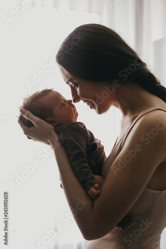Home portrait of happy mother and newborn baby	
