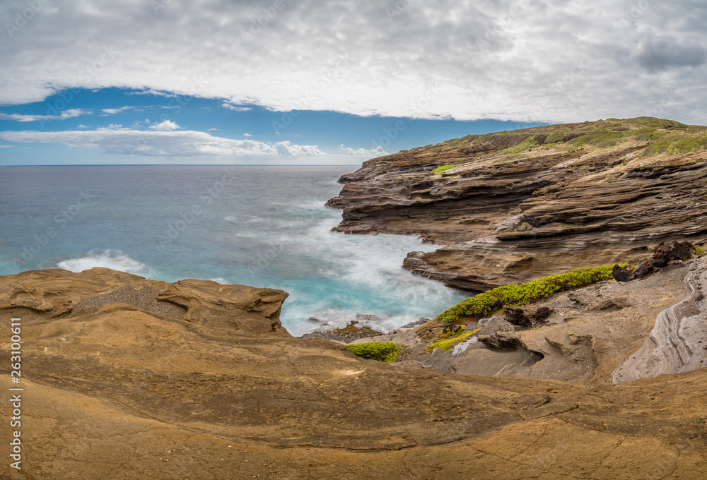Ocean waves swirling around the unique lava rock formations of the Lanai Lookout on Oahu, Hawaii