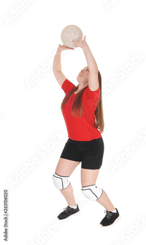 Pretty teenage girl playing volley ball