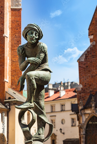 Bronze statue of a poor student near St Mary's Basilica located in Krakow, Poland photo