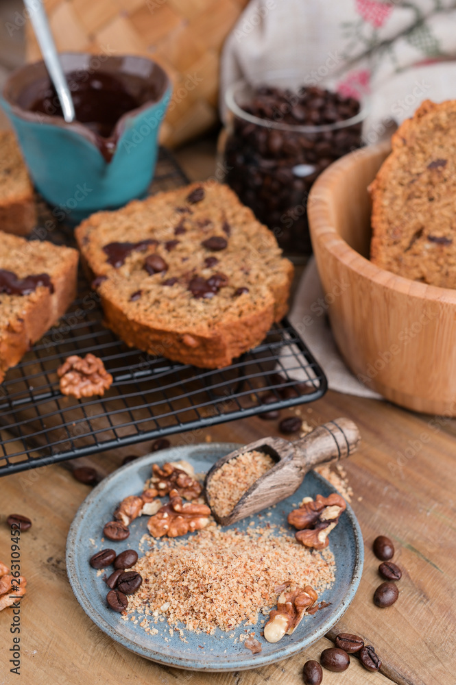 Fototapeta premium Cake with cocoa and chocolate on a wooden table. Sweet homemade pastries for breakfast. Rustic style photo.