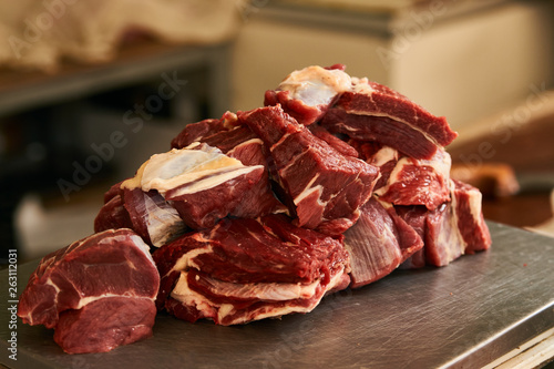 Fresh uncooked sliced meat on scales in meat market  