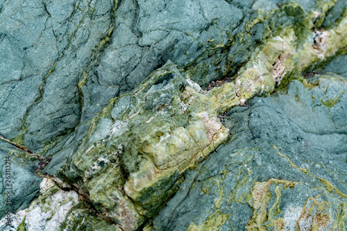 Background with green mineral rock close up, gemstone texture, olivine, amazonite, amphibolite photo