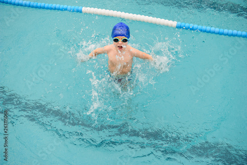 top view of a 7-year boy playing and swimming in the swimming pool © Med Photo Studio