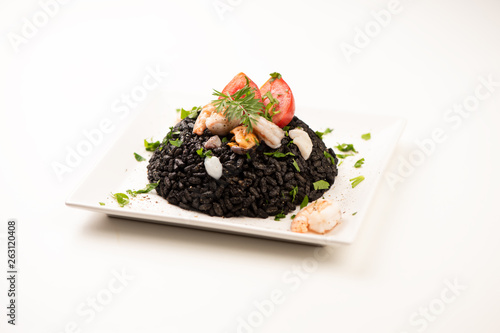 Black rice with cuttlefish on white photo