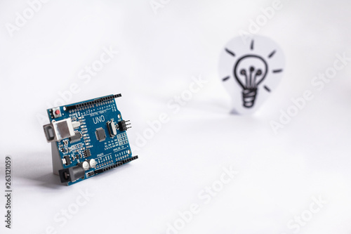 Arduino Uno. Arduino. Micro controller. Technology. Picture of a light bulb in the background. Idea. The science. Industrial. photo