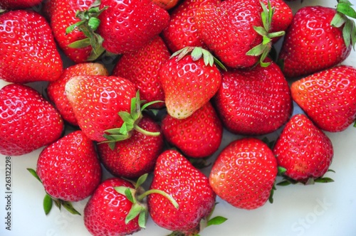 Red strawberries on a white background. Red berries. Berries for the cake. Strawberry basket. A group of berries. Fresh fruit and juicy fruit for fruit drink.