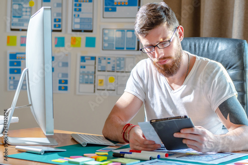 The designer compares the d...