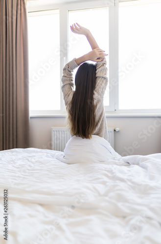 Wallpaper Mural Young woman stretching in the bed after wake up in the morning Torontodigital.ca