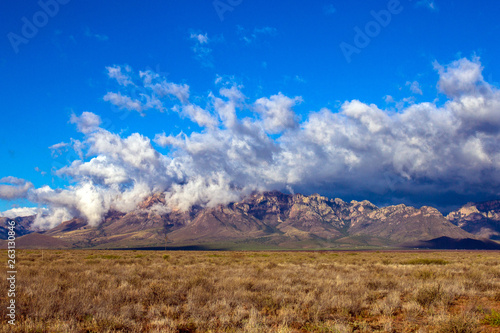 Arizona's Chiricahua Mountains under a large storm cloud photo