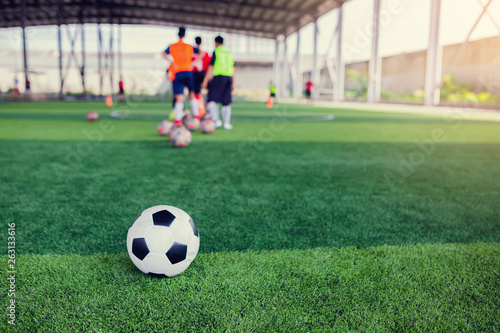 football on green artificial turf with blurry soccer team training © Koonsiri