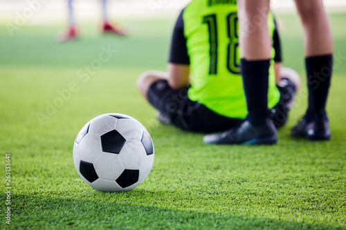 soccer ball on green artificial turf with blurry soccer players © Koonsiri