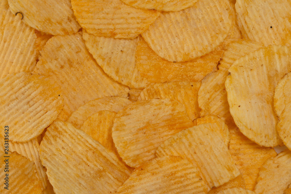 Close-up lot of tasty rippled yellow potato chips background Close-up lot of tasty rippled yellow potato chips background