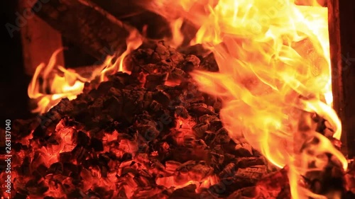 Home style footage. Sound. Extreme close-up video of a burning picnic bench at the end of a party by a body of water. Summer holidays fun or malicious destruction of property. Raging flames, intense.