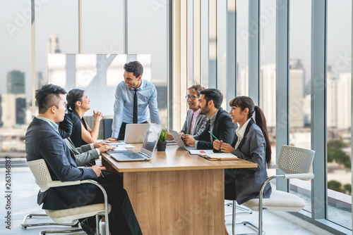 Businesspeople discussing together in conference room during meeting at office.