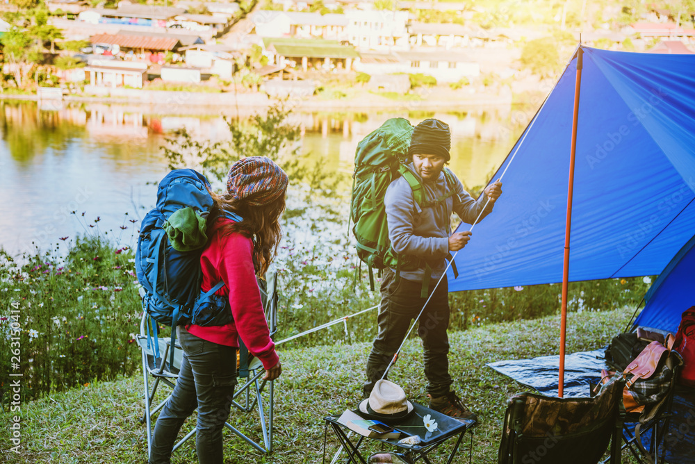 Couple Enjoying Camping Holiday In Countryside.Camp in the mountains near  of the lake. Help to camps the tent Stock Photo | Adobe Stock