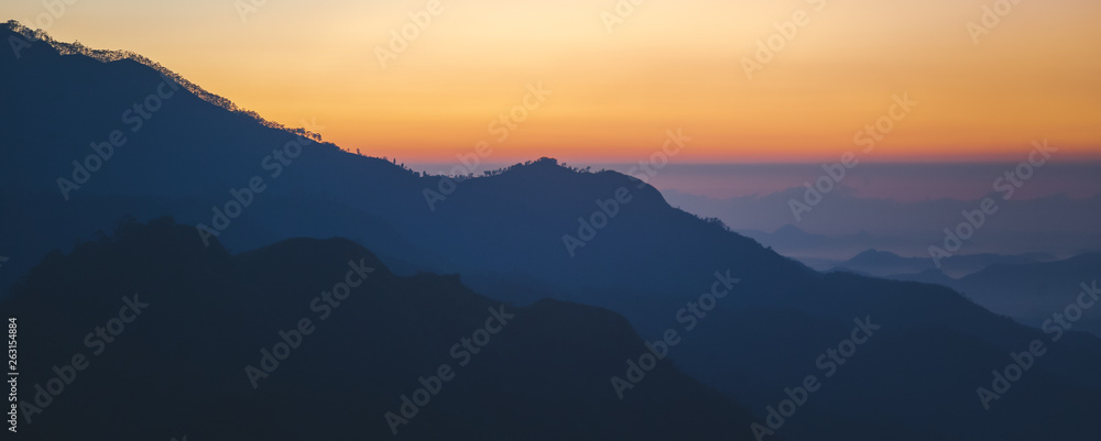Majestic sunset in the mountains landscape with sunny beams. Dramatic scene. Sri Lanka Ella rock