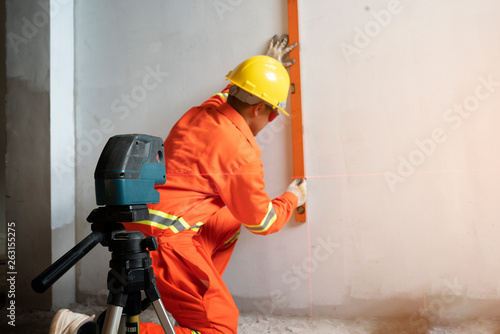 Technician with Laser measurement level during work