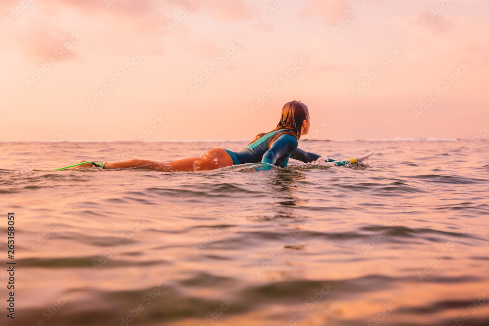 Photo Art Print Surfgirl with perfect body on a surfboard floating in ocean artifirsov