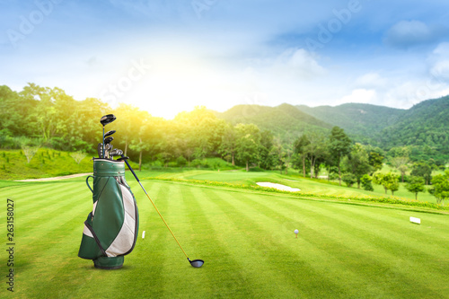 Golf equipment and golf bag golf ball on green at golf course  sunset blue sky as background