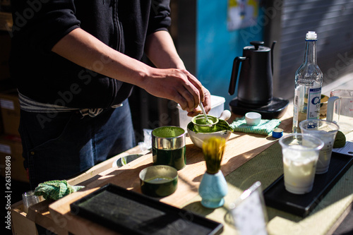 Japanese man making matcha green tea in tokyo street stall ginza